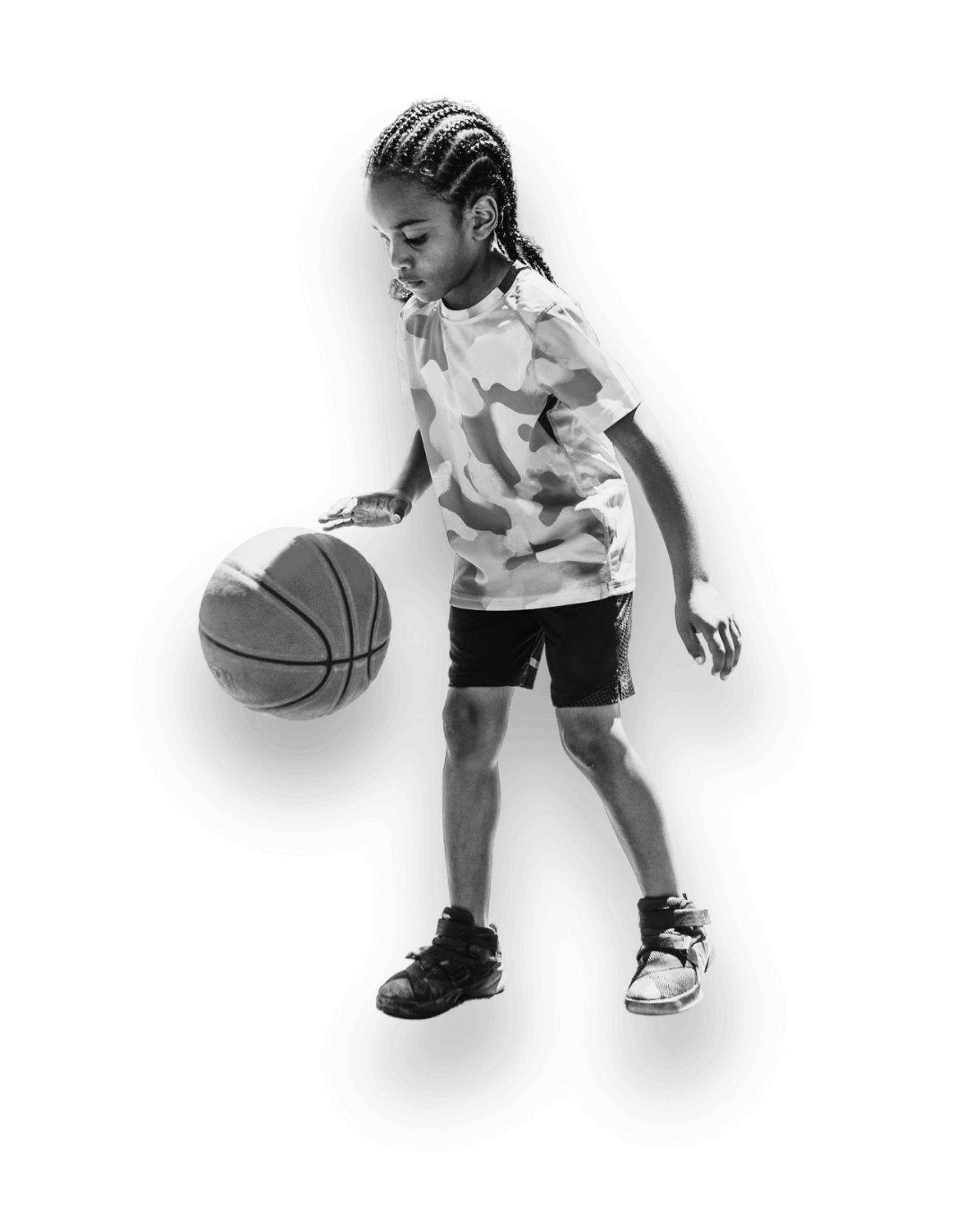 young child dribbling a basketball
