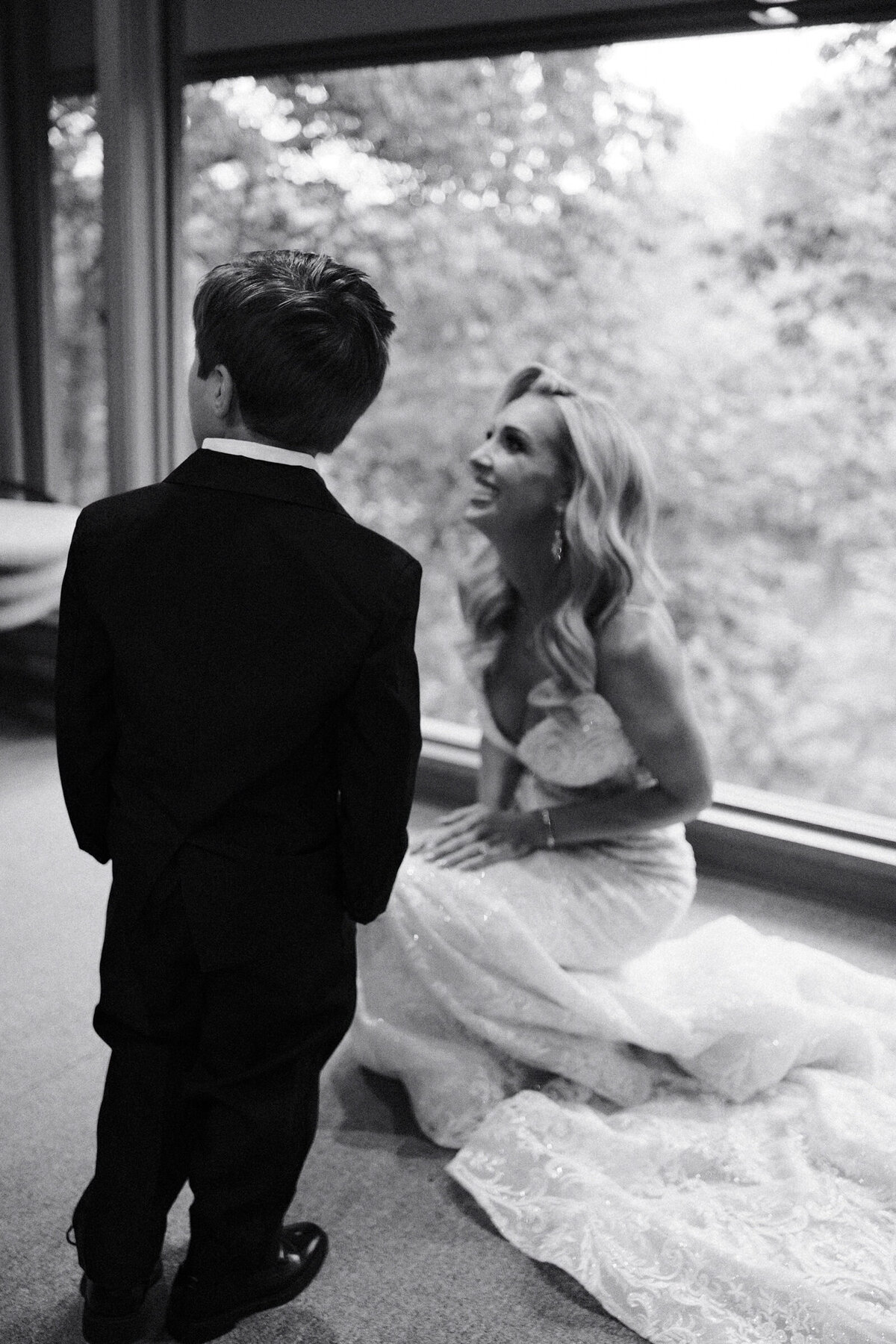 A blak and white wedding photo of the bride with her ring bearer in Arkansas
