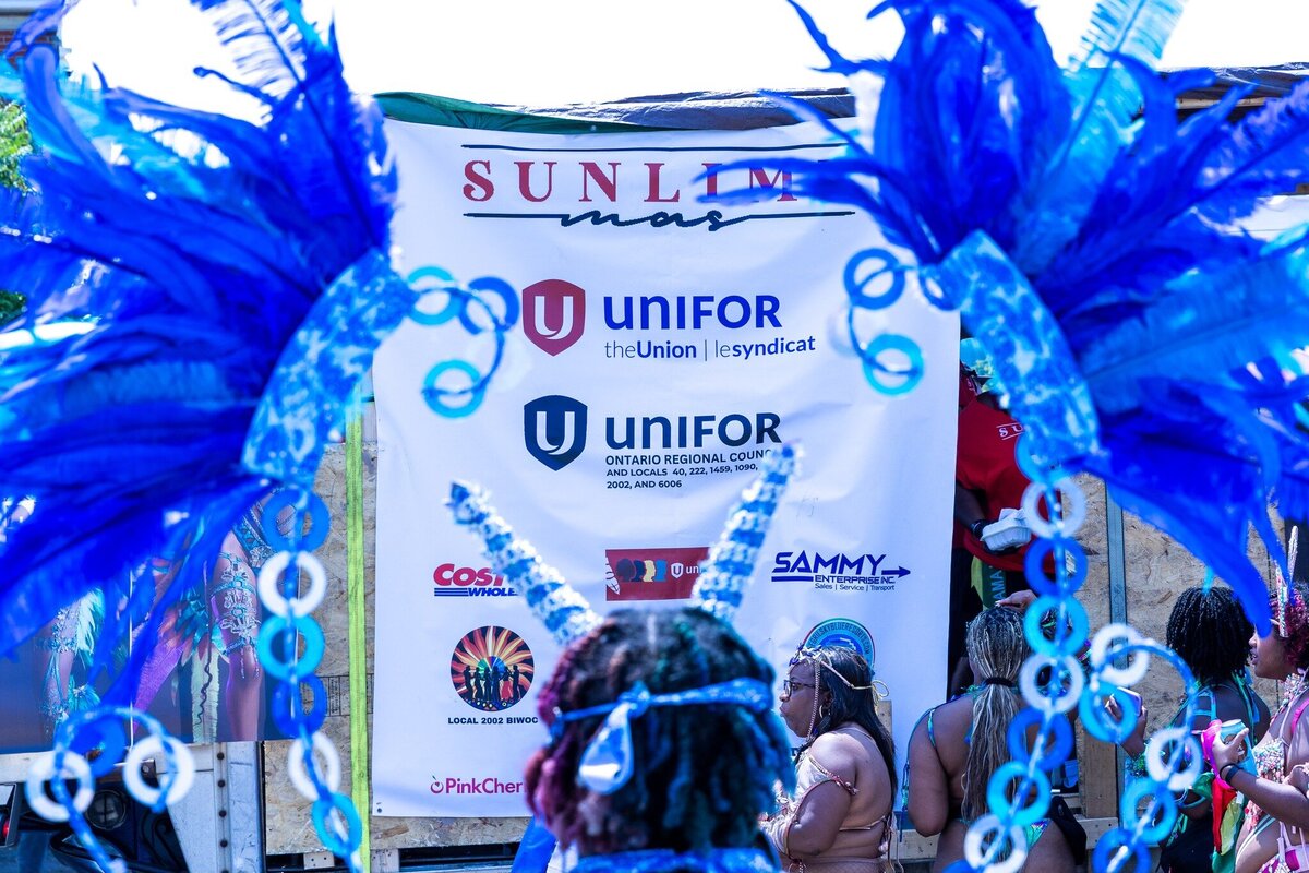 Toronto caribbean carnival parade masqueraders having fun in costume with Sunlime Mas, the number 1 medium size band at Toronto Carnival.