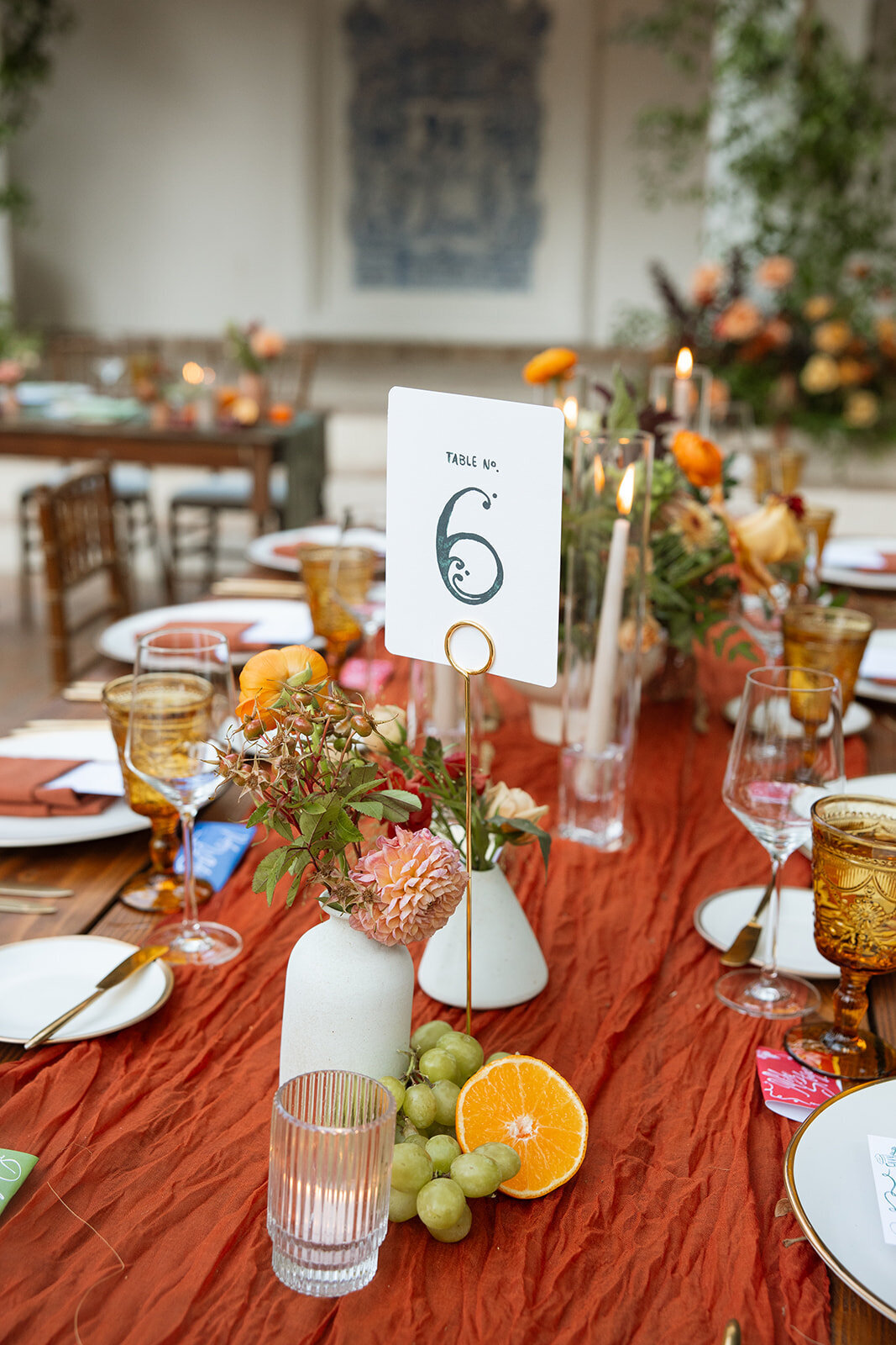 Terracotta runners on wooden tables at wedding reception at Rancho Las Lomas