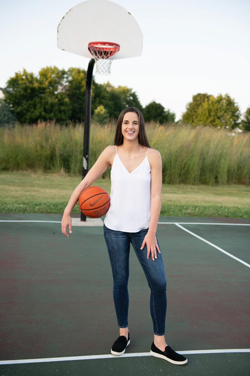 Caitlin clark as a senior girl on a basketball court, fame in her future