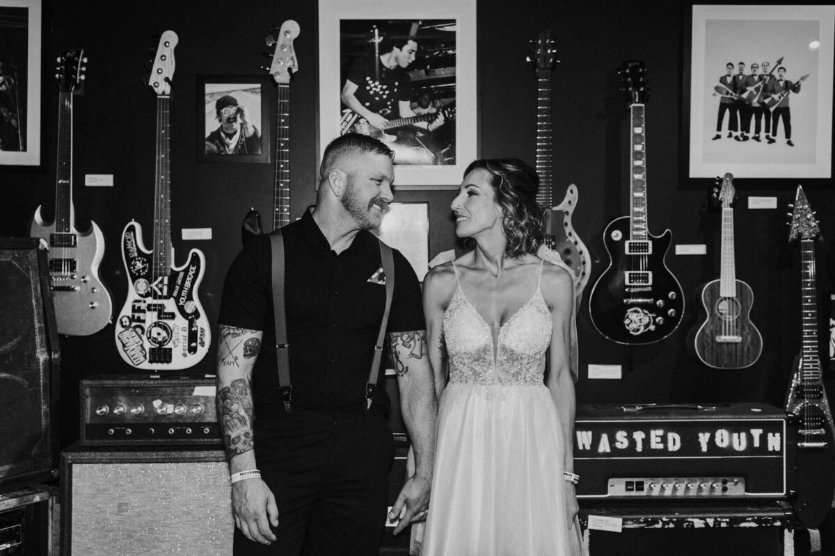 Two people hold hands and look at each other at the Punk Rock Museum.