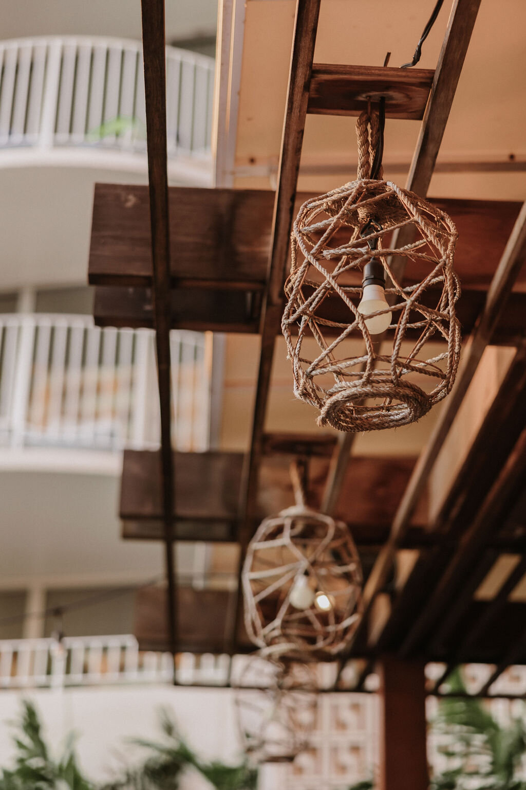 small lantern decorations made of twine hanging from rafter