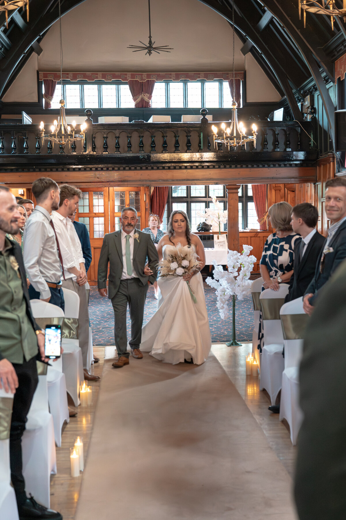 Bride walking down the aisle during wedding ceremony at Worsley Court House, Manchester wedding photographer