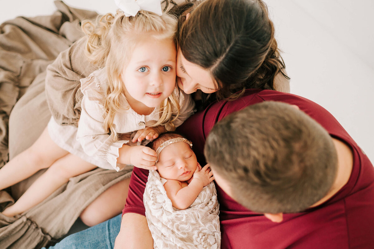 parenting cuddling their girls during Springfield MO newborn photogrpahy session