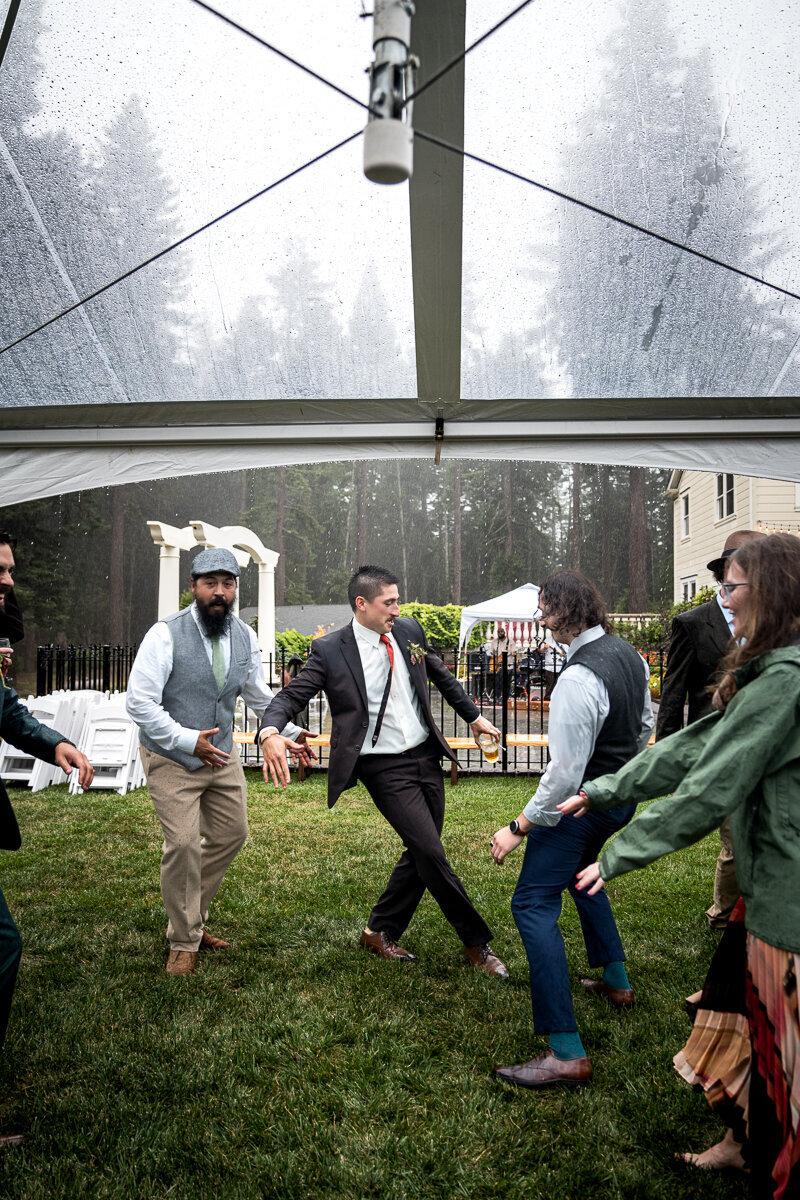 Wedding guests enjoying the dance floor in the rain at Ridgefield in Arcata, celebrating with laughter, joy, and unforgettable memories despite the weather.