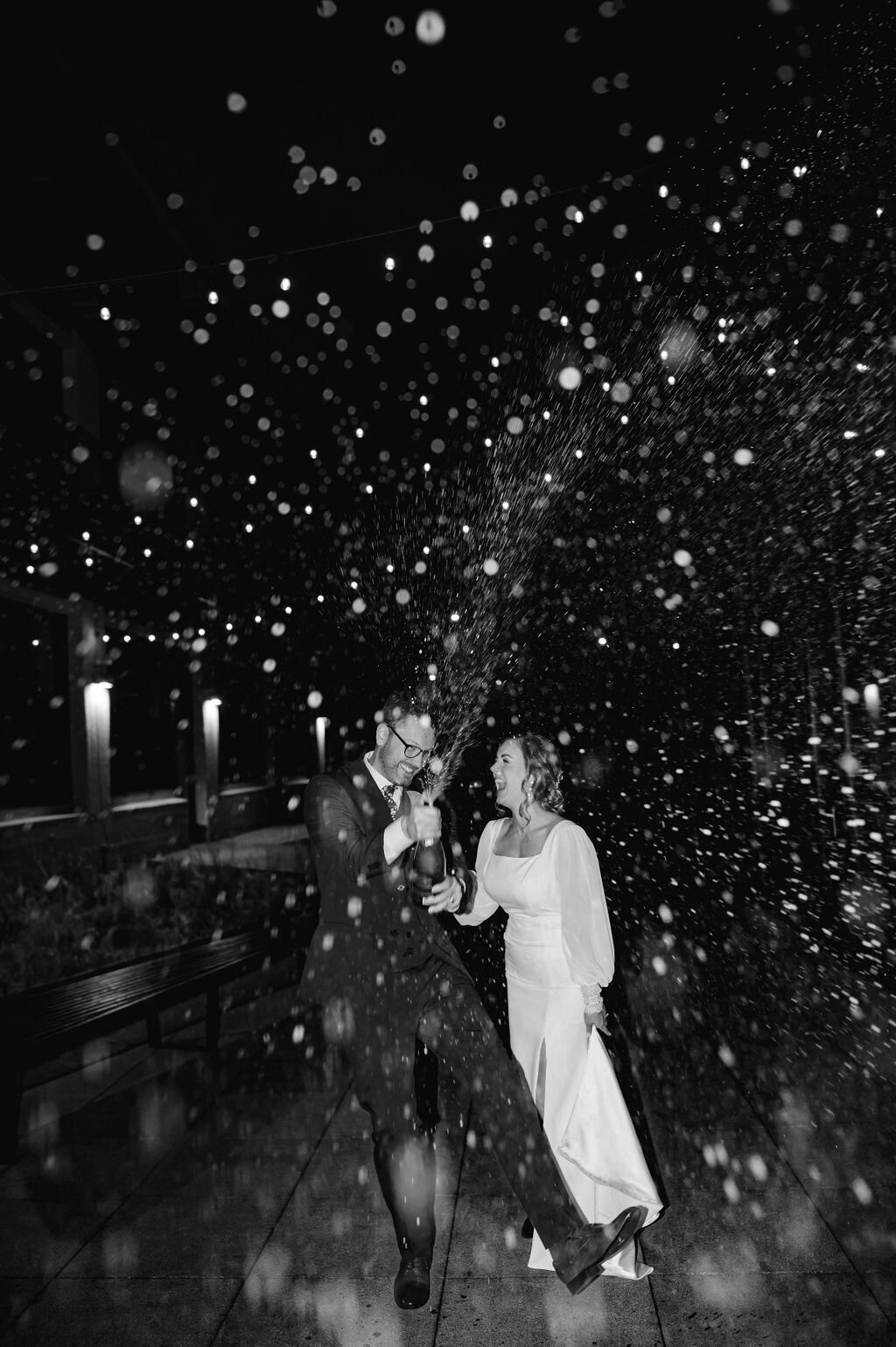 Bride and groom spray champagne  at Greenhouse Loft in Chicago, IL