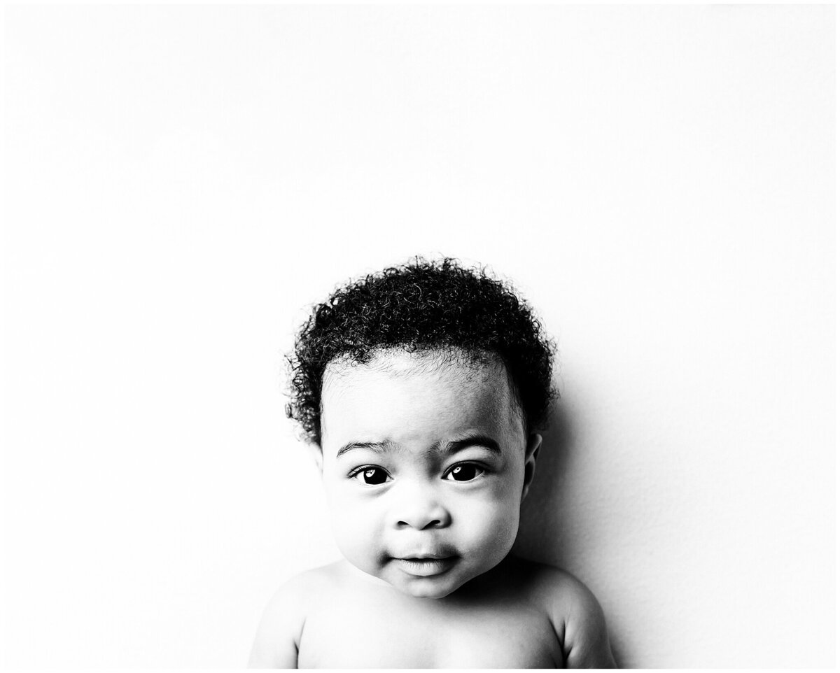 A beautiful 3 month old child portrait in black and white, highlighting their natural beauty .