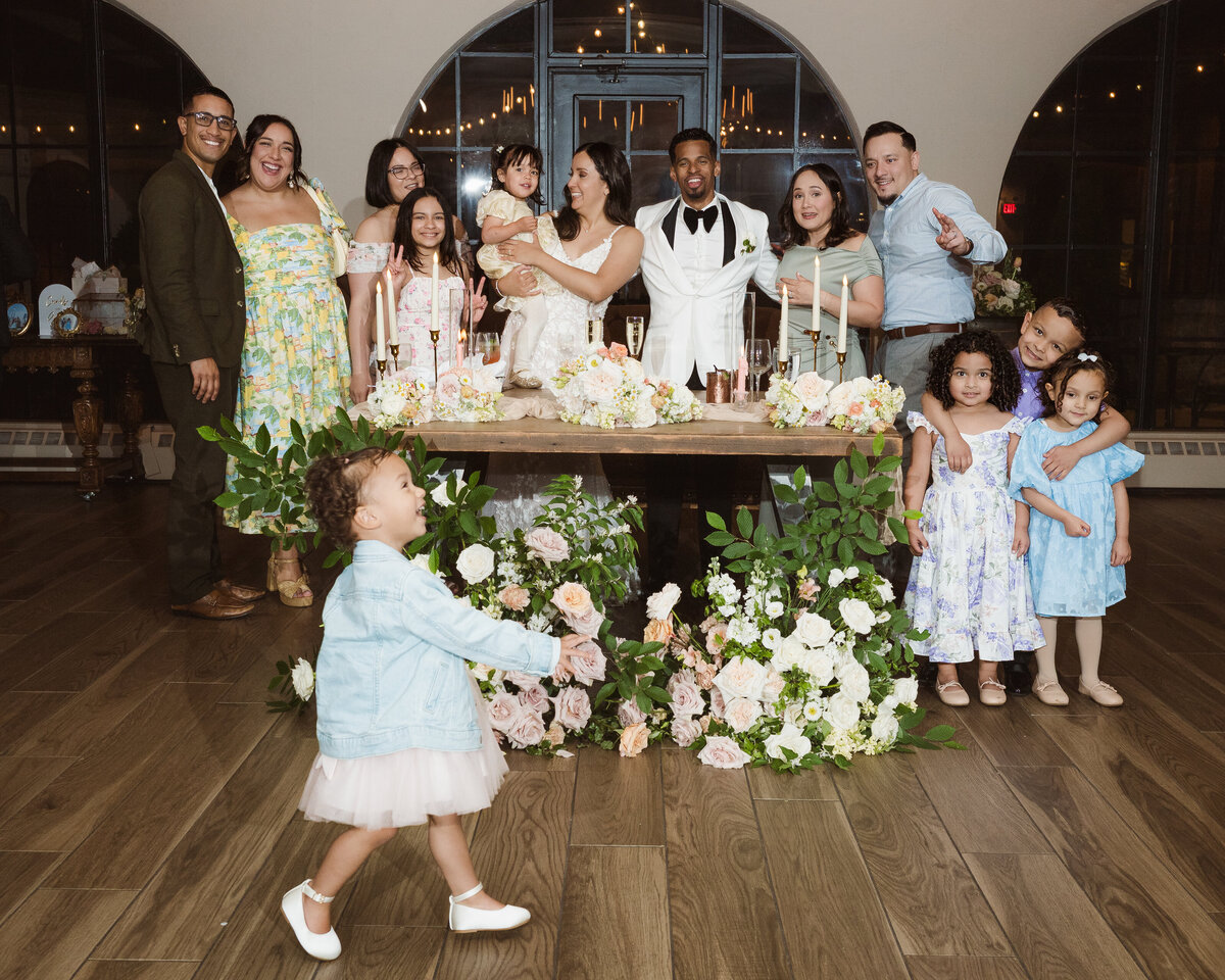 funny moment of flower girl photobombing family photo