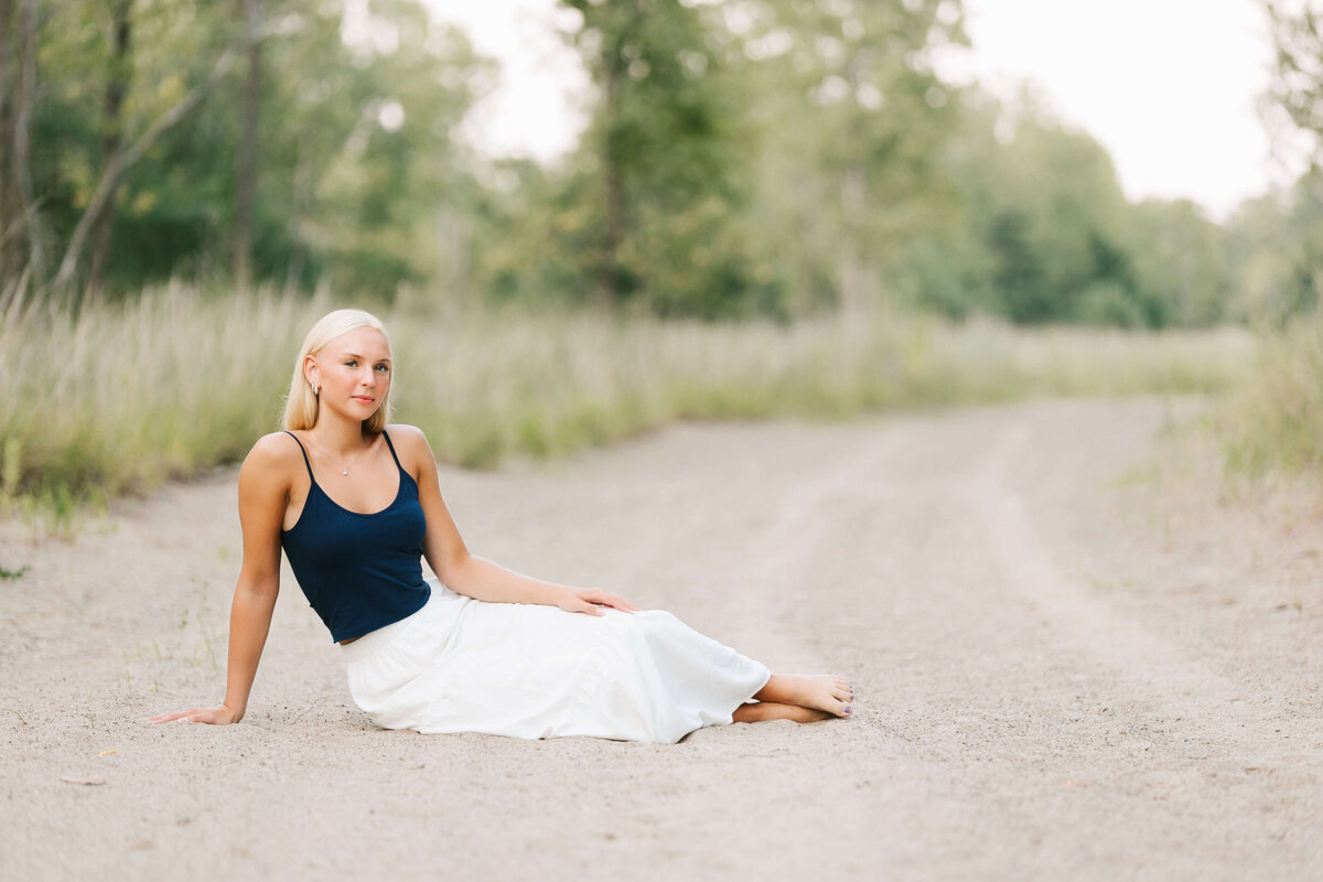 Erie Pa high school senior sitting in the sand on the beach in Erie Pa