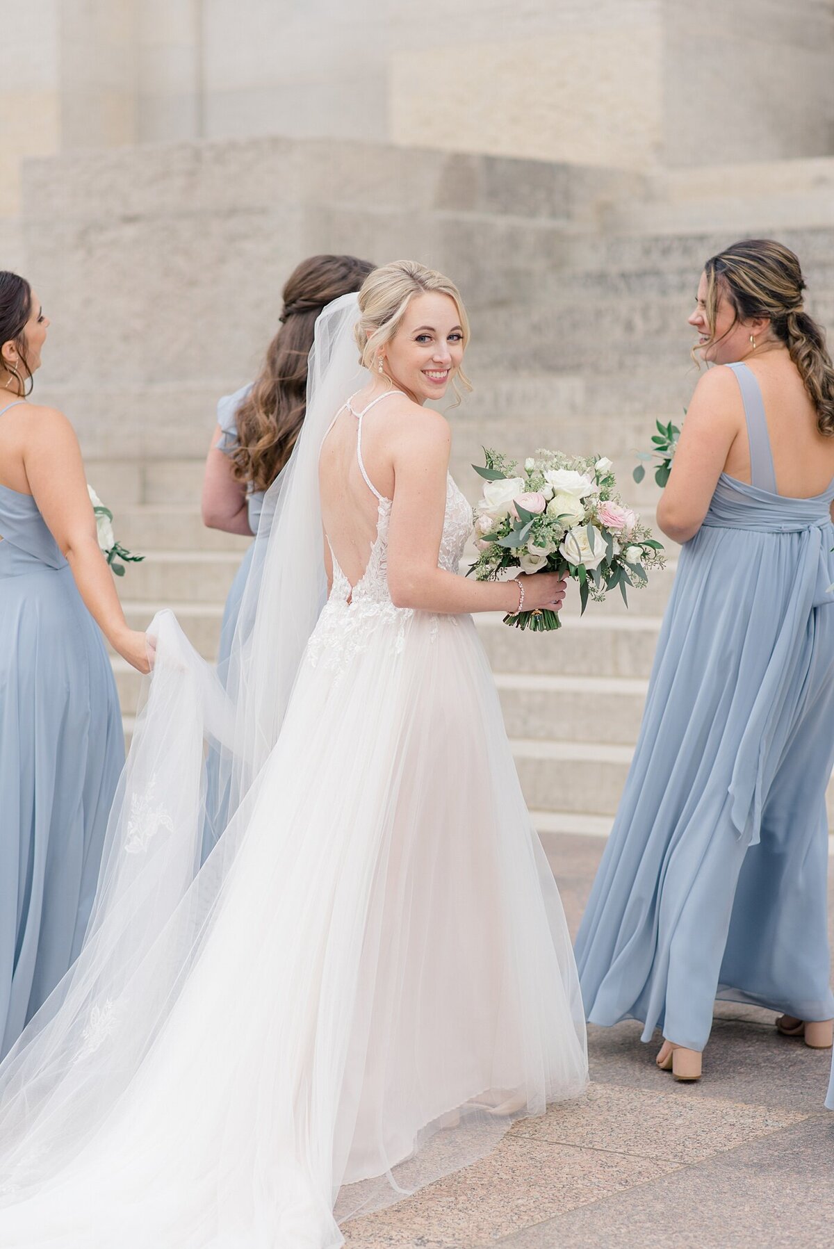 Bride walking with bridesmaids at the Ohio State House taken by Columbus, Ohio wedding photographer