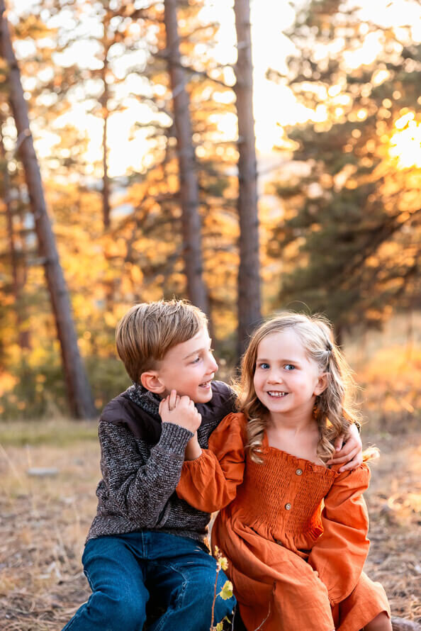 A boy and girl pose for the camera during their photos with Angela Marie Media.