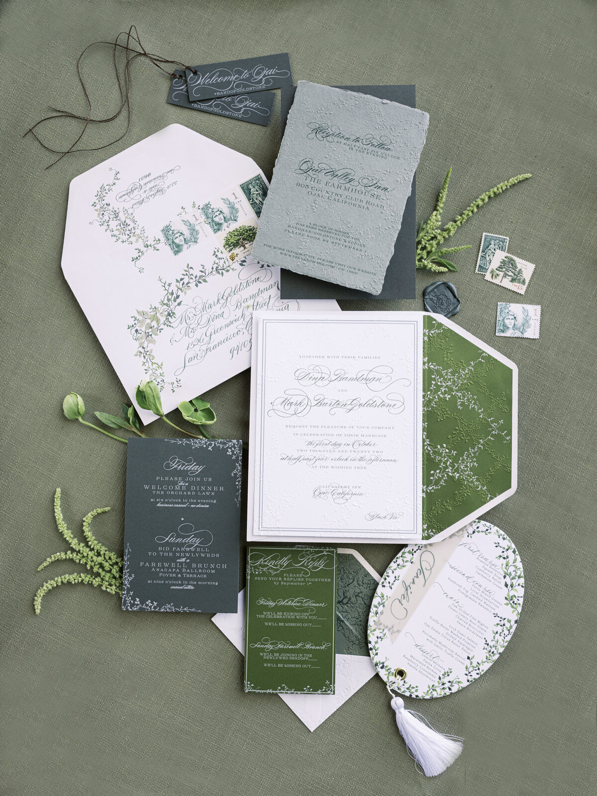 Teal, blue and green stationery suite for Santa Barbara Wedding with fresh greens and travel stamps