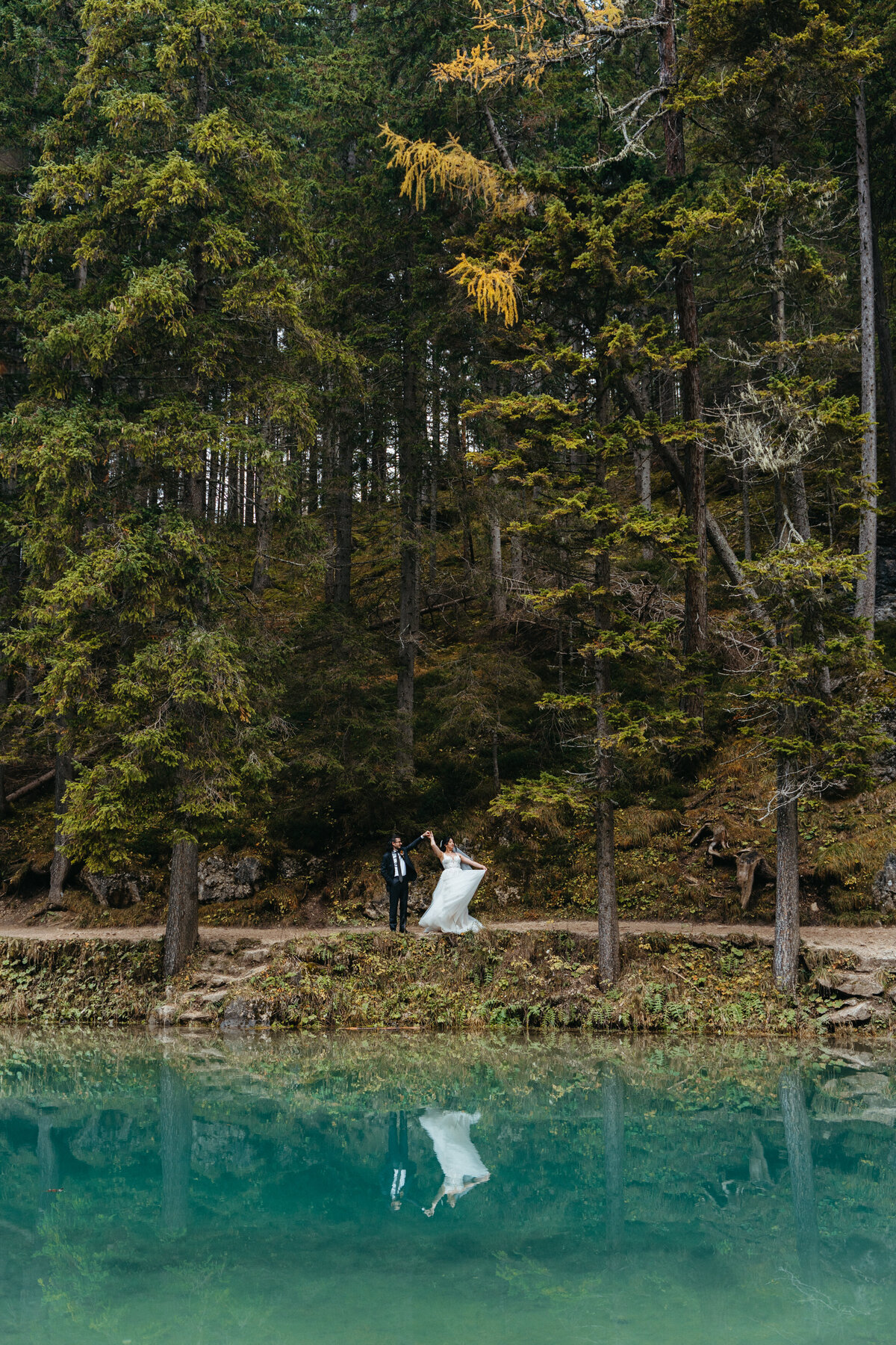 Couple dancing by forest edge at Lago di Braies