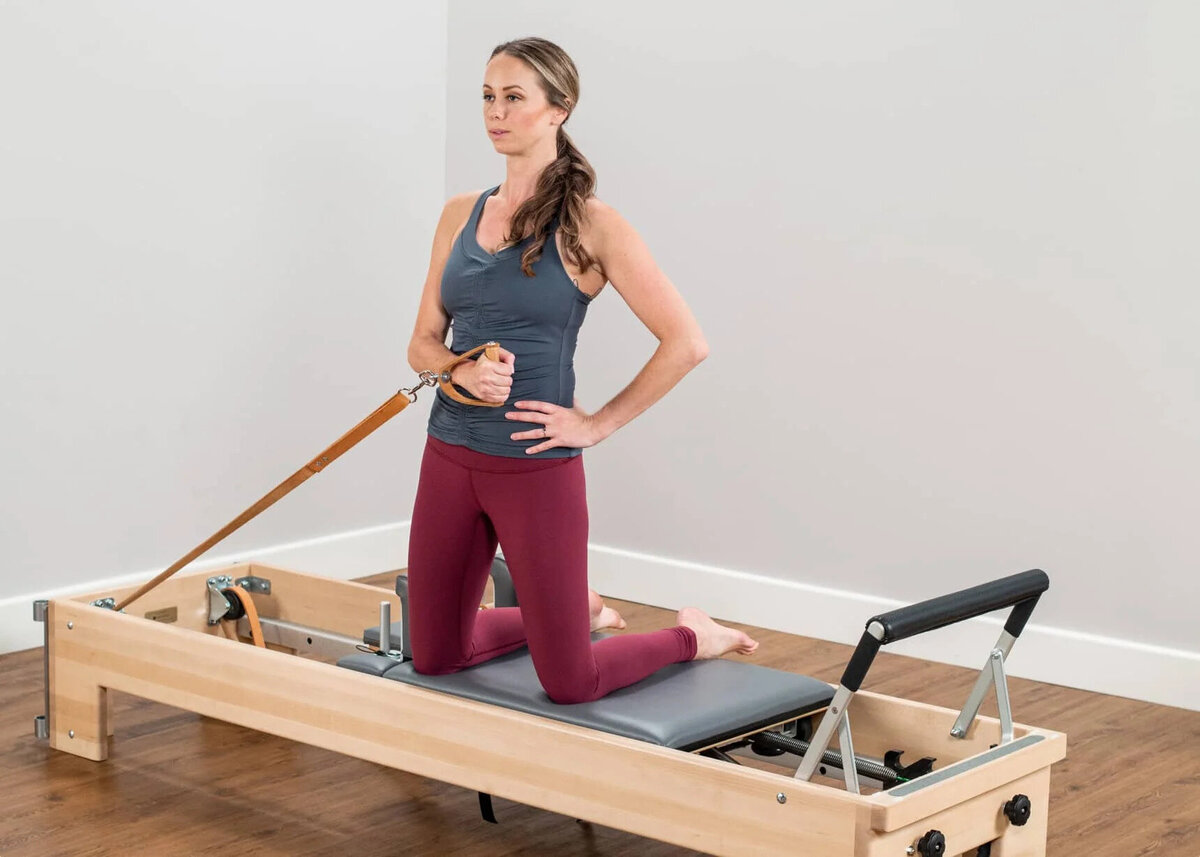 What Pilates can do for your body: Woman doing a Classical Pilates exercise on the reformer