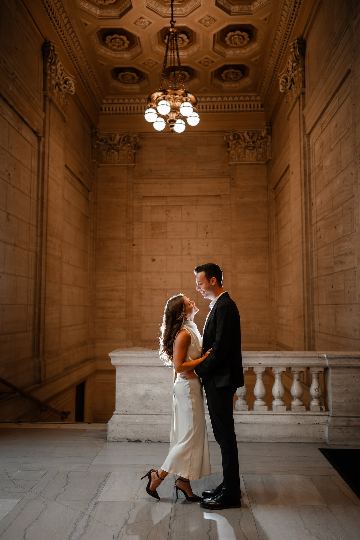 A couple hold each other in a grand space at Union Station