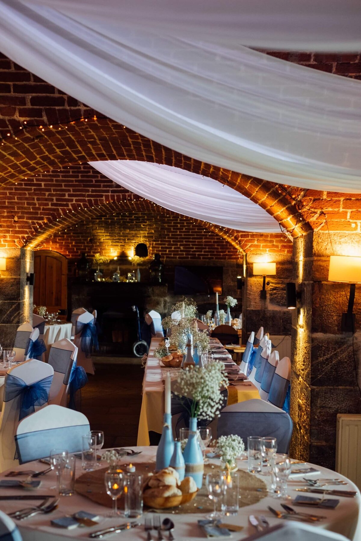 A wedding breakfast setup with long an round tables