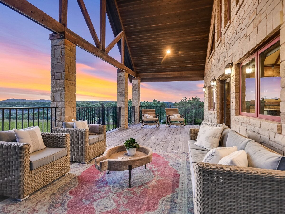 Exterior balcony seating area with beautiful view and decorative carpet