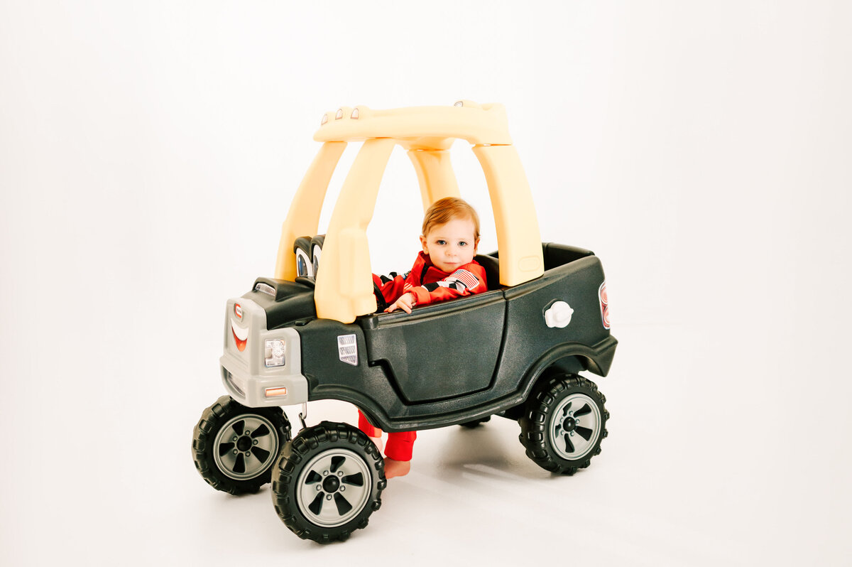 boy sitting in truck seriously in Springfield MO photography studio