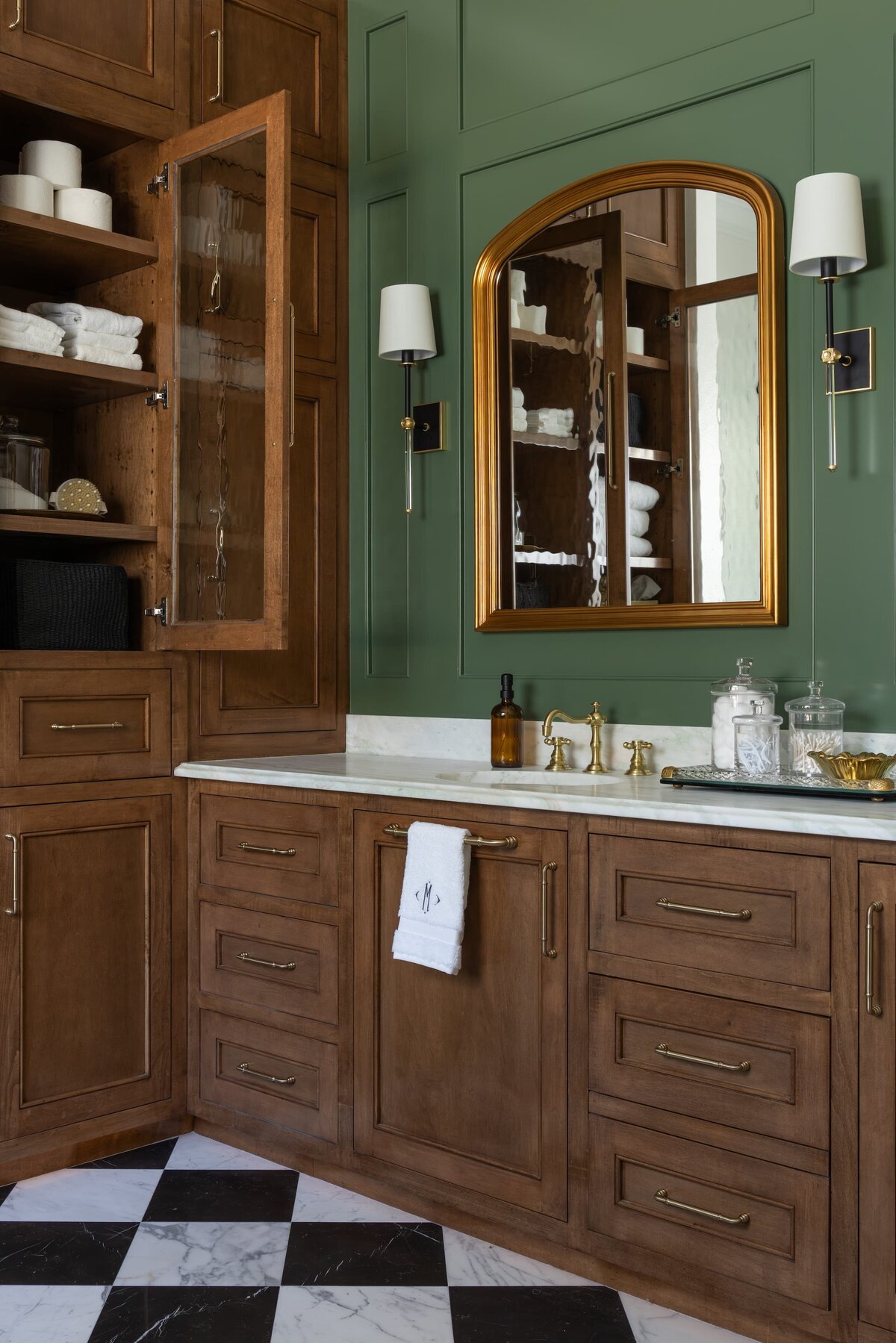 kyleen bushroe interiors coverdell bathroom with dark wood and gold framed mirror