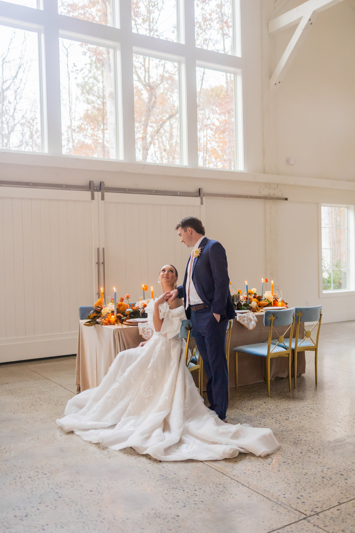 bride and groom at the reception at Carolina Grove in Raleigh North Carolina  with elegant tablescape with candles by North Carolina Wedding Photographer Amanda Richardson Photography