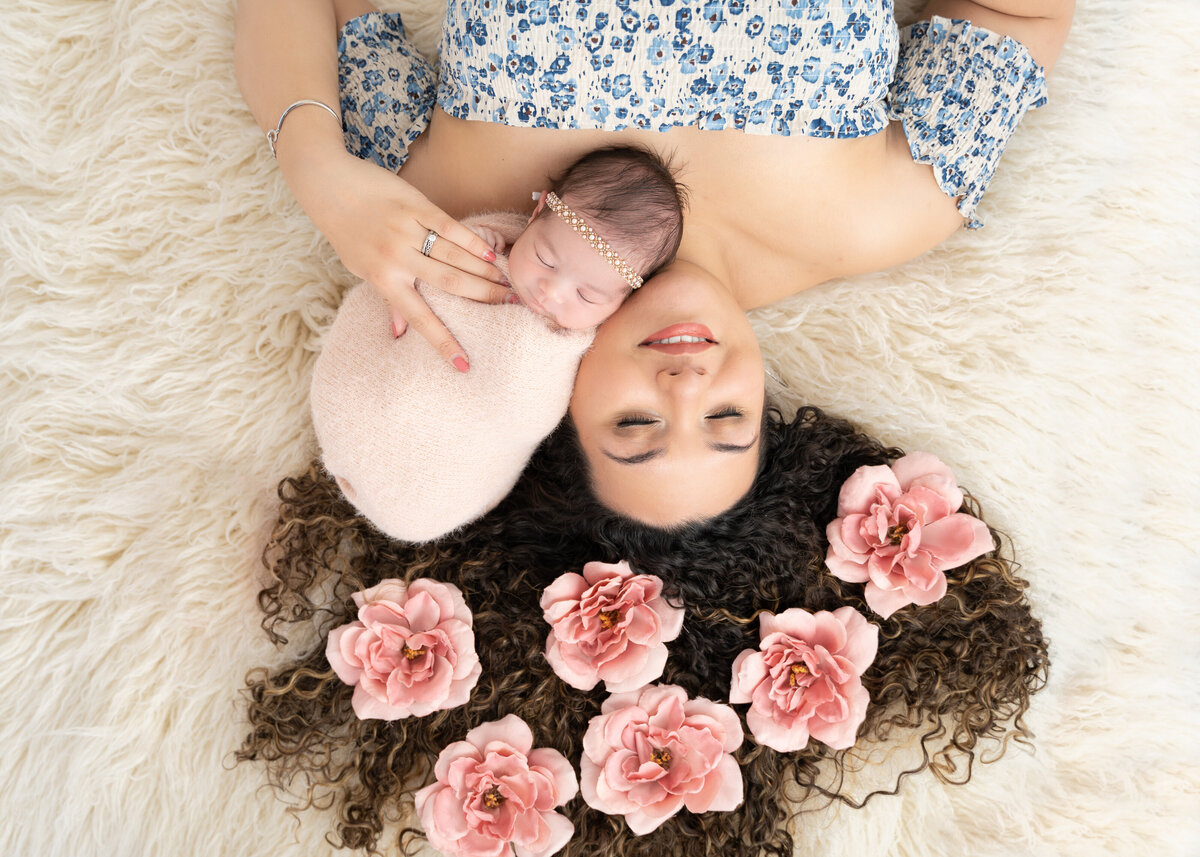 mom and newborn pose floral