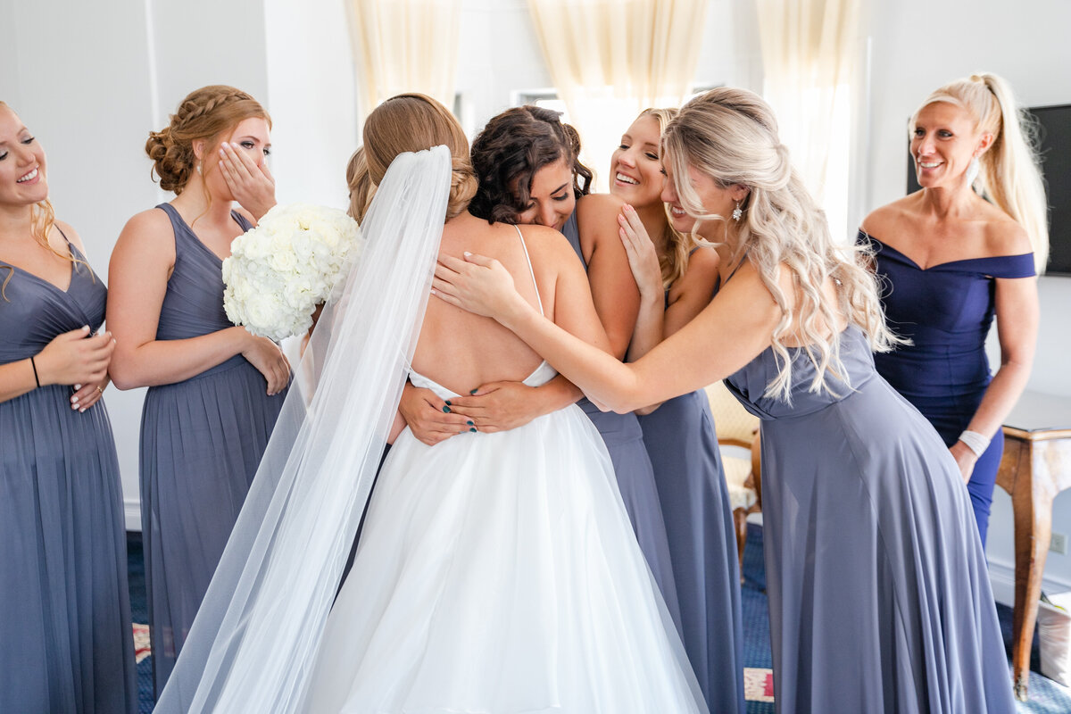 bride-and-bridesmaids-sharing-hugs