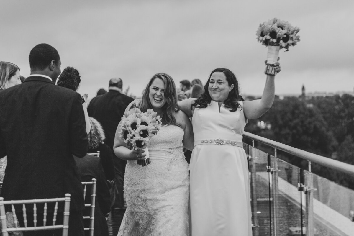 Newlyweds walking back up the aisle smiling and celebrating 