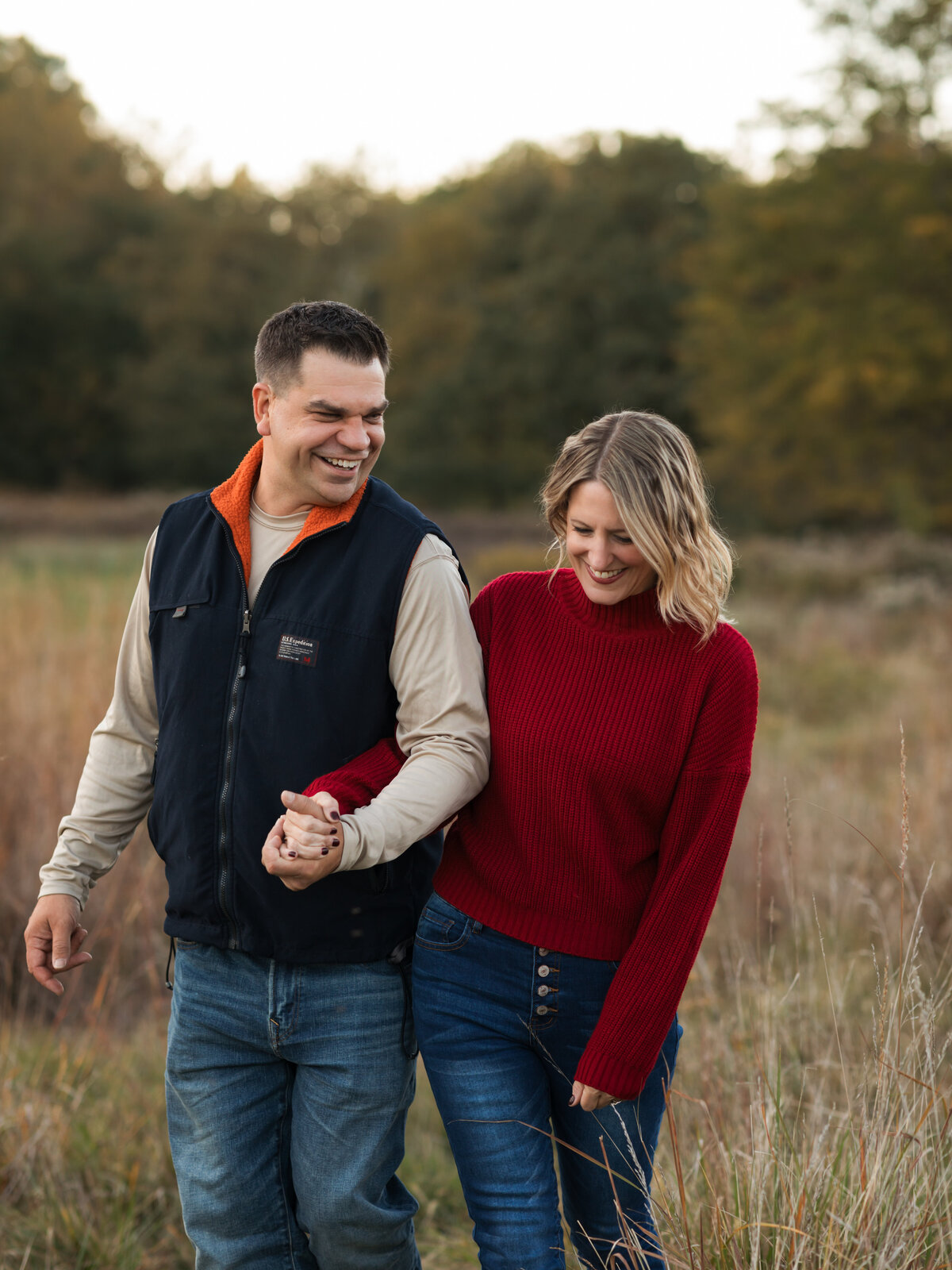 husband and wife walking and laughing in park for family photos cleveland family photography