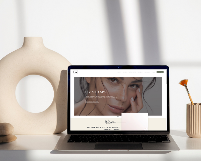 Laptop screen displaying a premium, soft-toned homepage created for a medspa or holistic wellness clinic.

