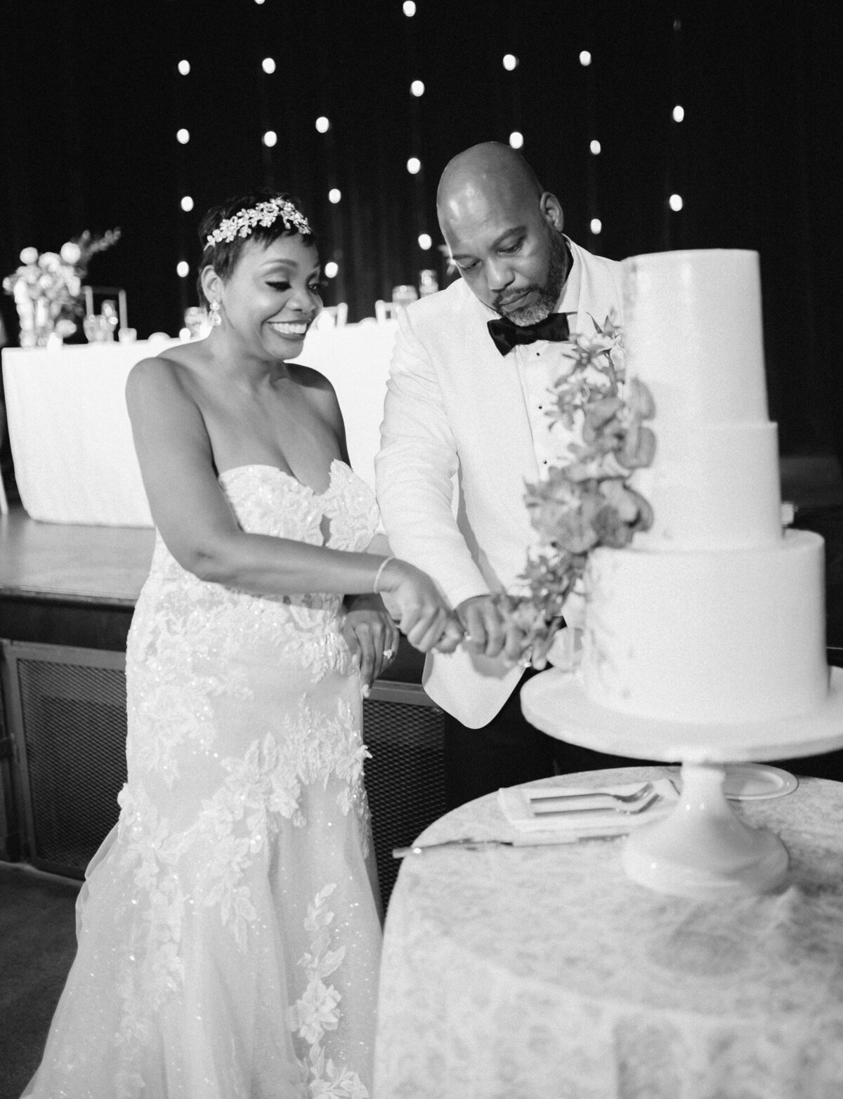 black wedding couple cuts cake at Garden Theater wedding reception in Detroit, unique Detroit wedding venue