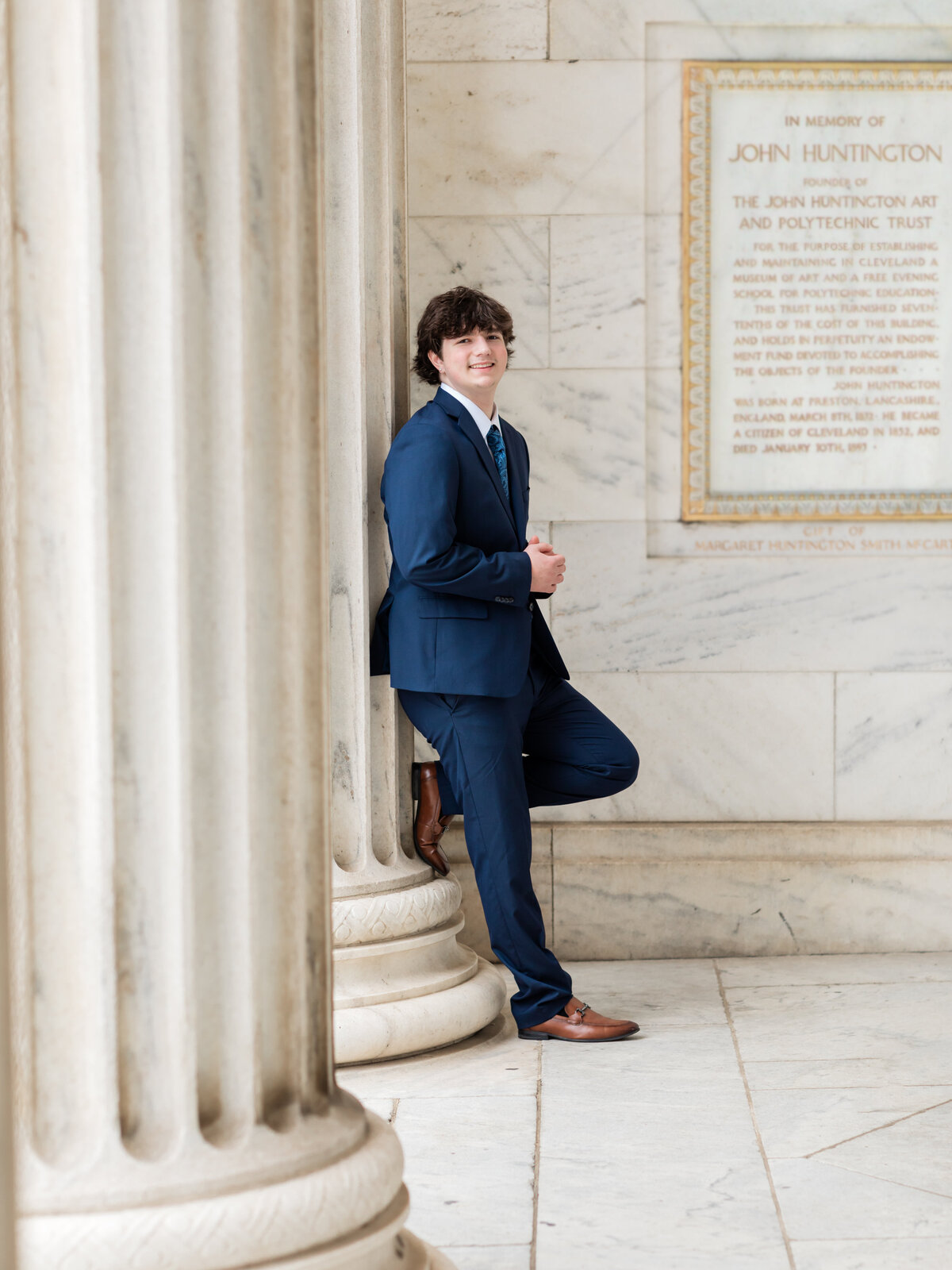 high school senior boy in blue suit posed at Cleveland Museum of Art for portraits Cleveland senior photographer