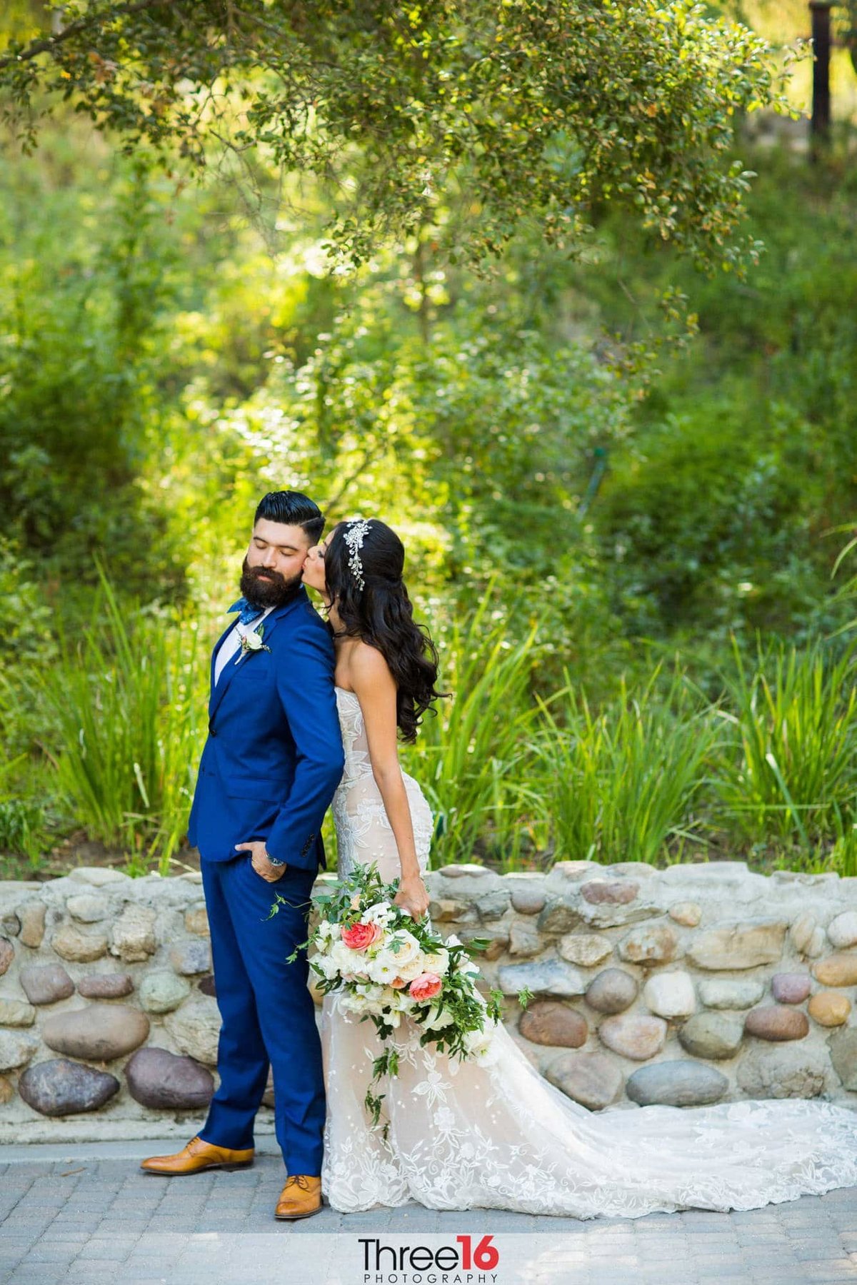 Bride kisses her Groom on the cheek from behind