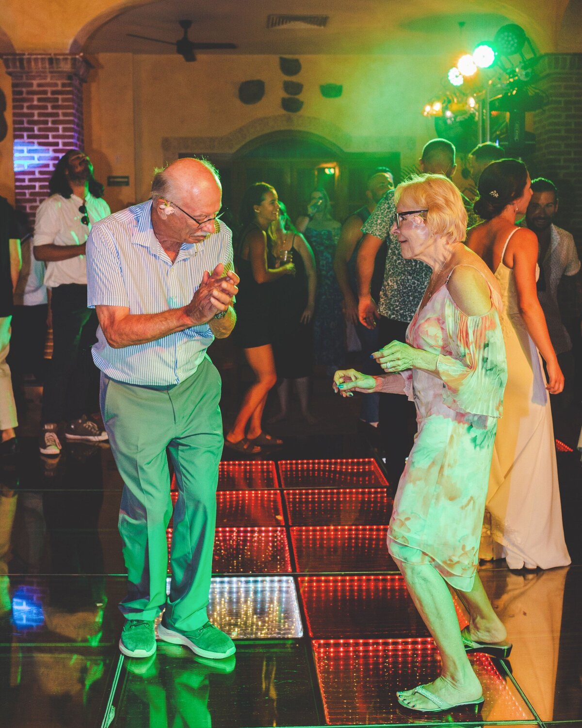 Older couple dancing at wedding reception in Riviera Maya