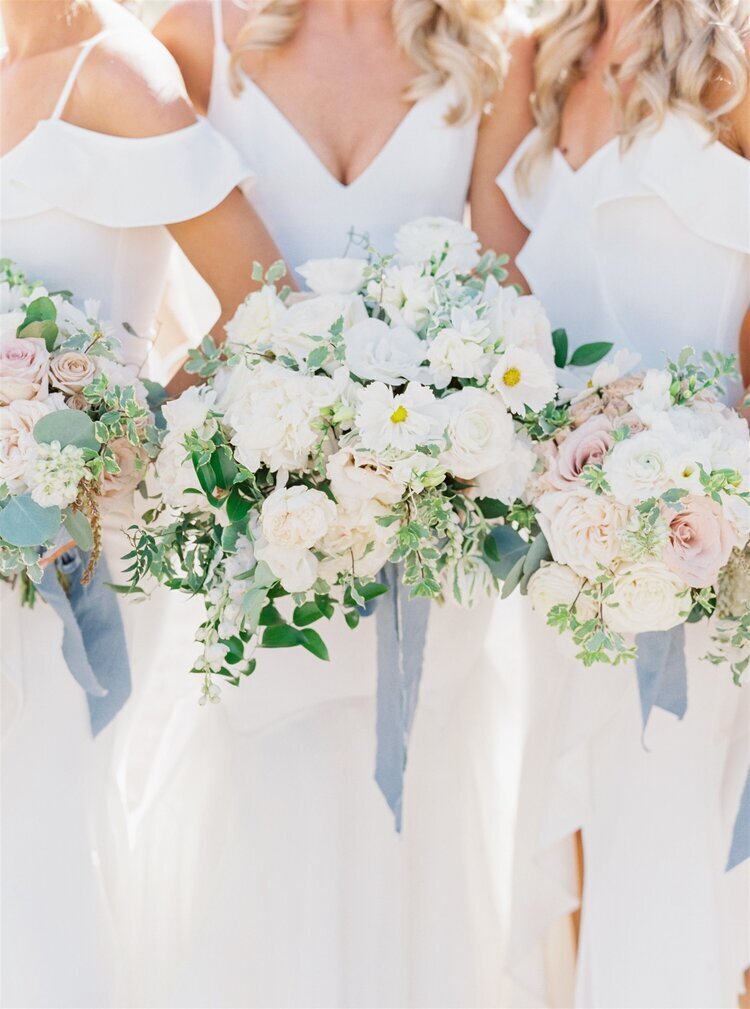 Bridal party bouquets white and peach with green foliage