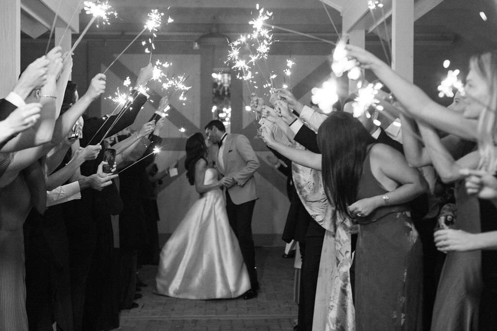 brideandgroom-kiss-before-entering-sparkler-tunnel