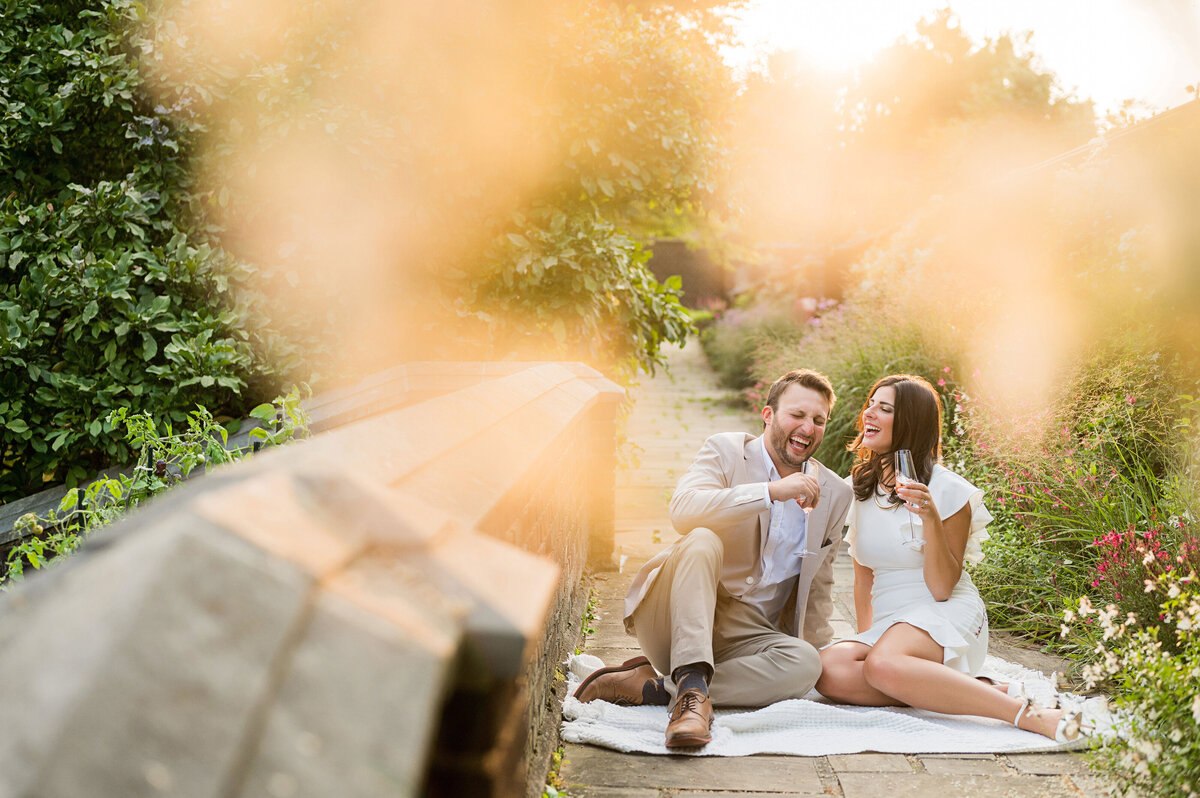 engegement picture of couple with champagne at frick park