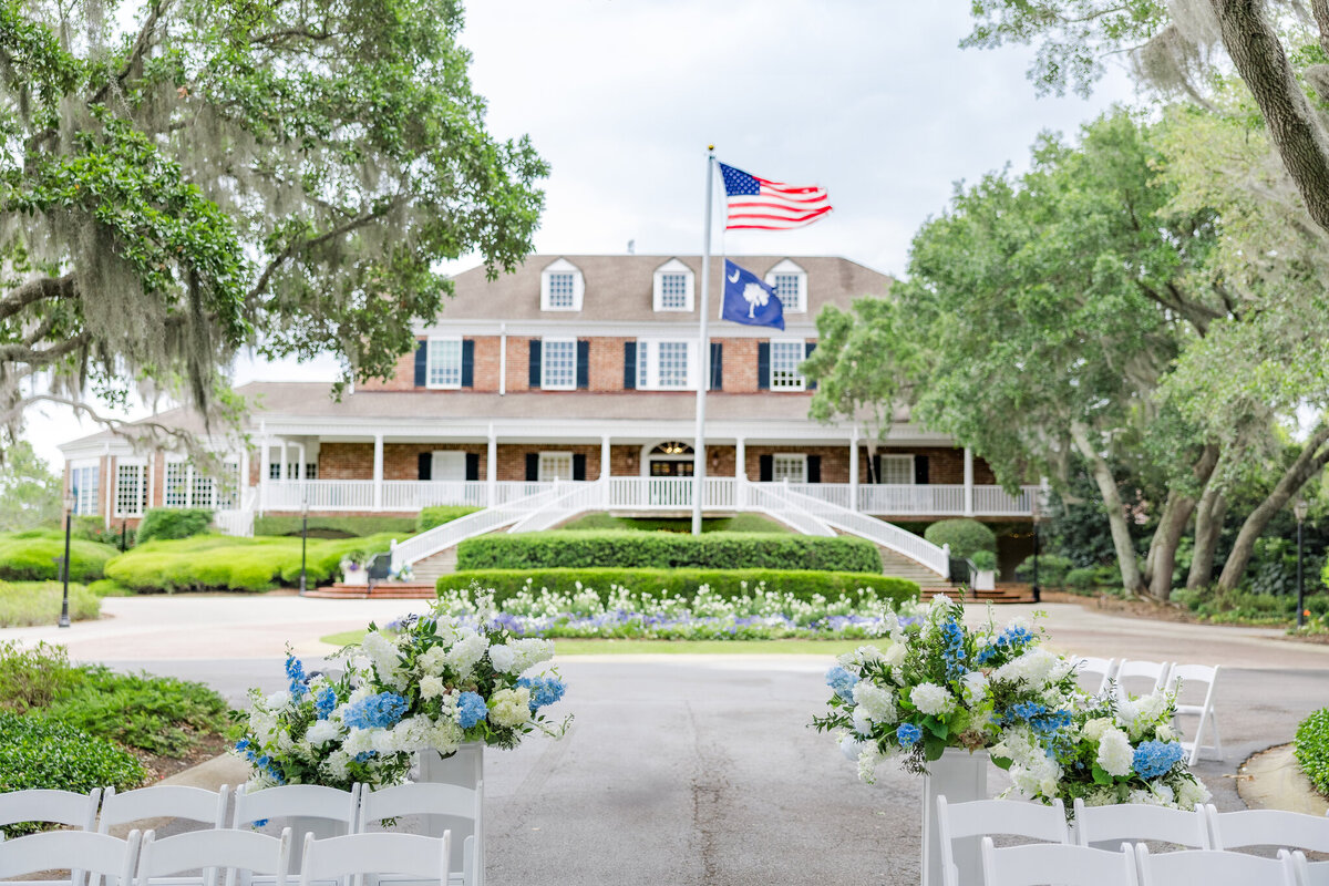a wedding venue with a grand lawn that is adorned with plants and flowers