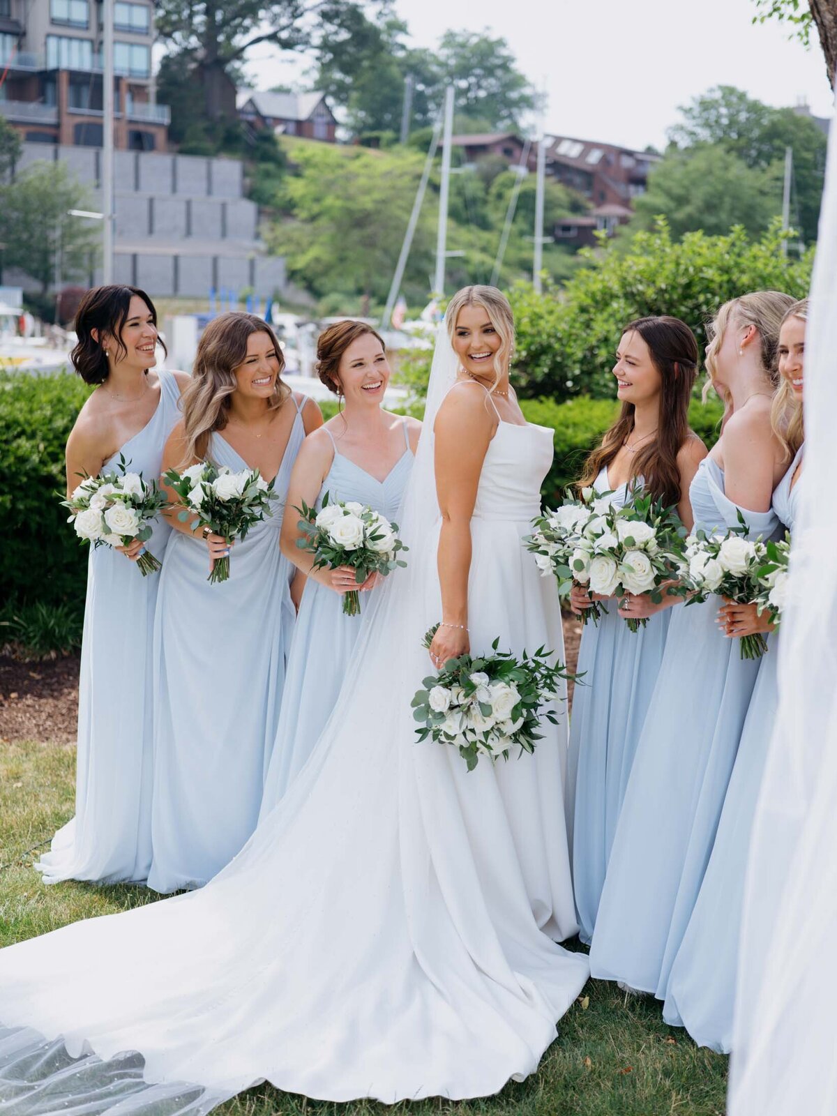 Bride with bridesmaids in light blue dresses at Cleveland Yachting Club