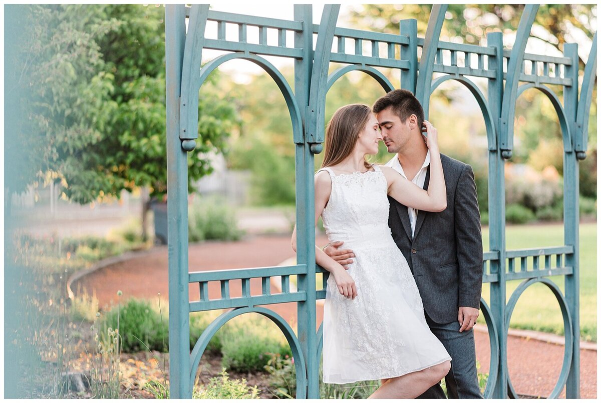 couple embraces on bridge captured by denver wedding photographer