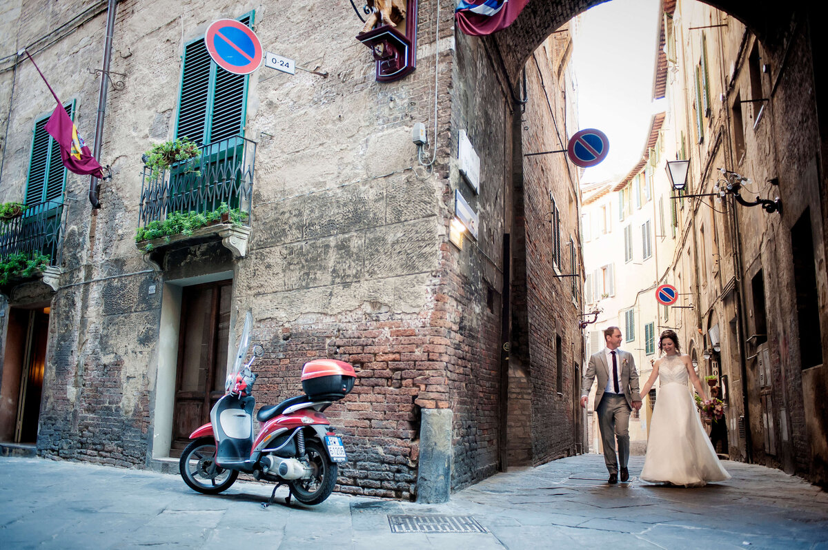 moped-wedding-couple-walking-around-sienna-italy