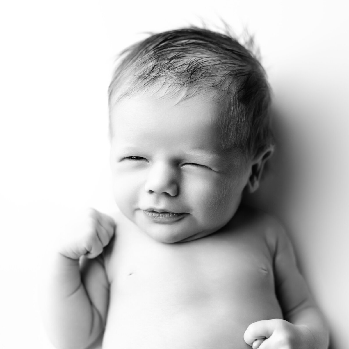 A one-of-a-kind wink from your one-of-a-kind baby. Captured in soulful black and white.