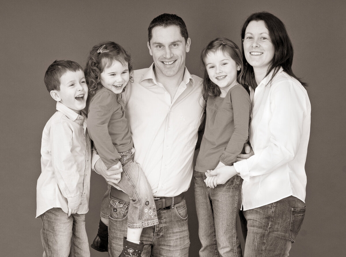 black & white family portrait in studio wearing denim