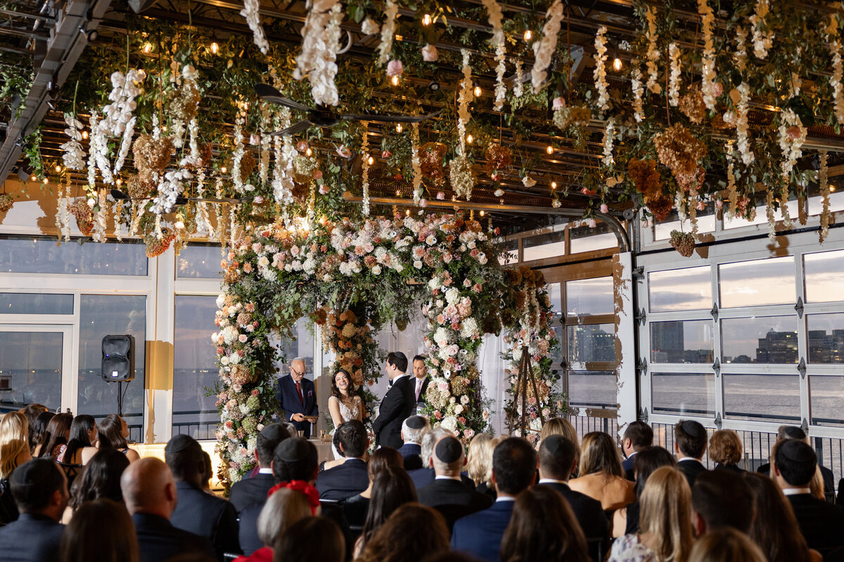 a wide shot of sarah laughing during the ceremony 