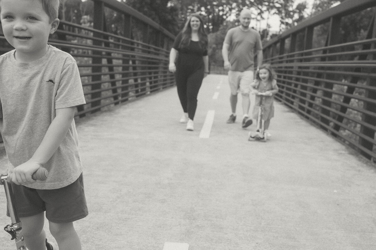 A family of four walks and rides their scooters at Noonday Creek Trail.