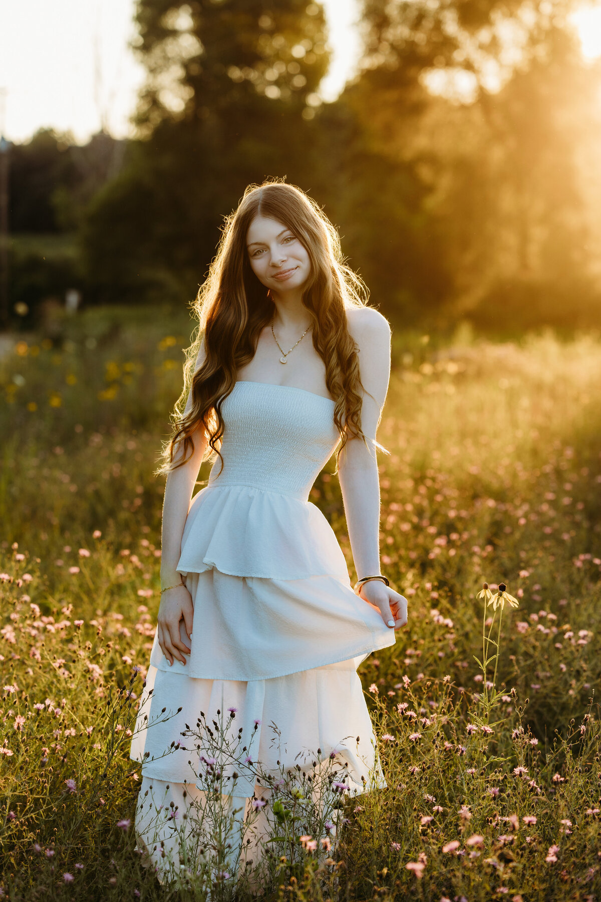 senior-girl-standing-in-wildflower-field