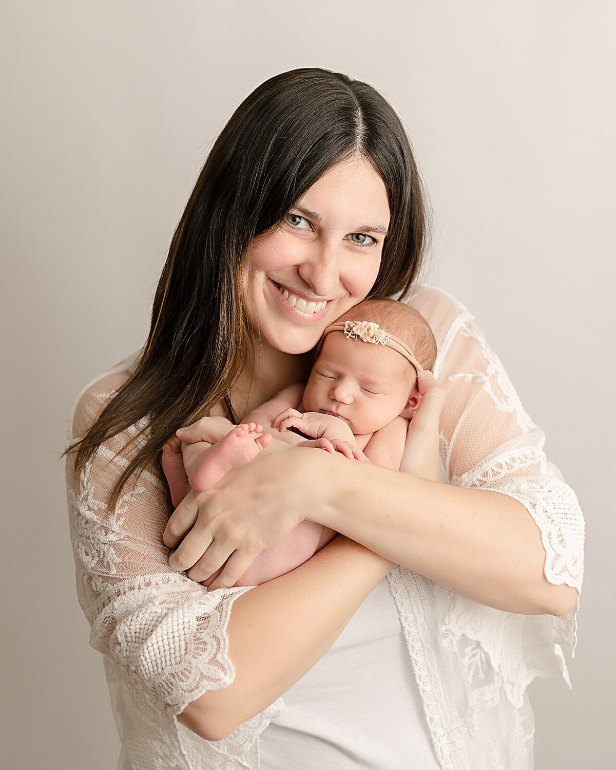 baby girl and smiling mom in portland newborn session