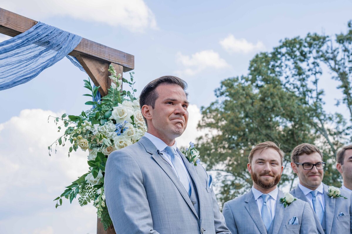 groom seeing his bride for the first time crying
