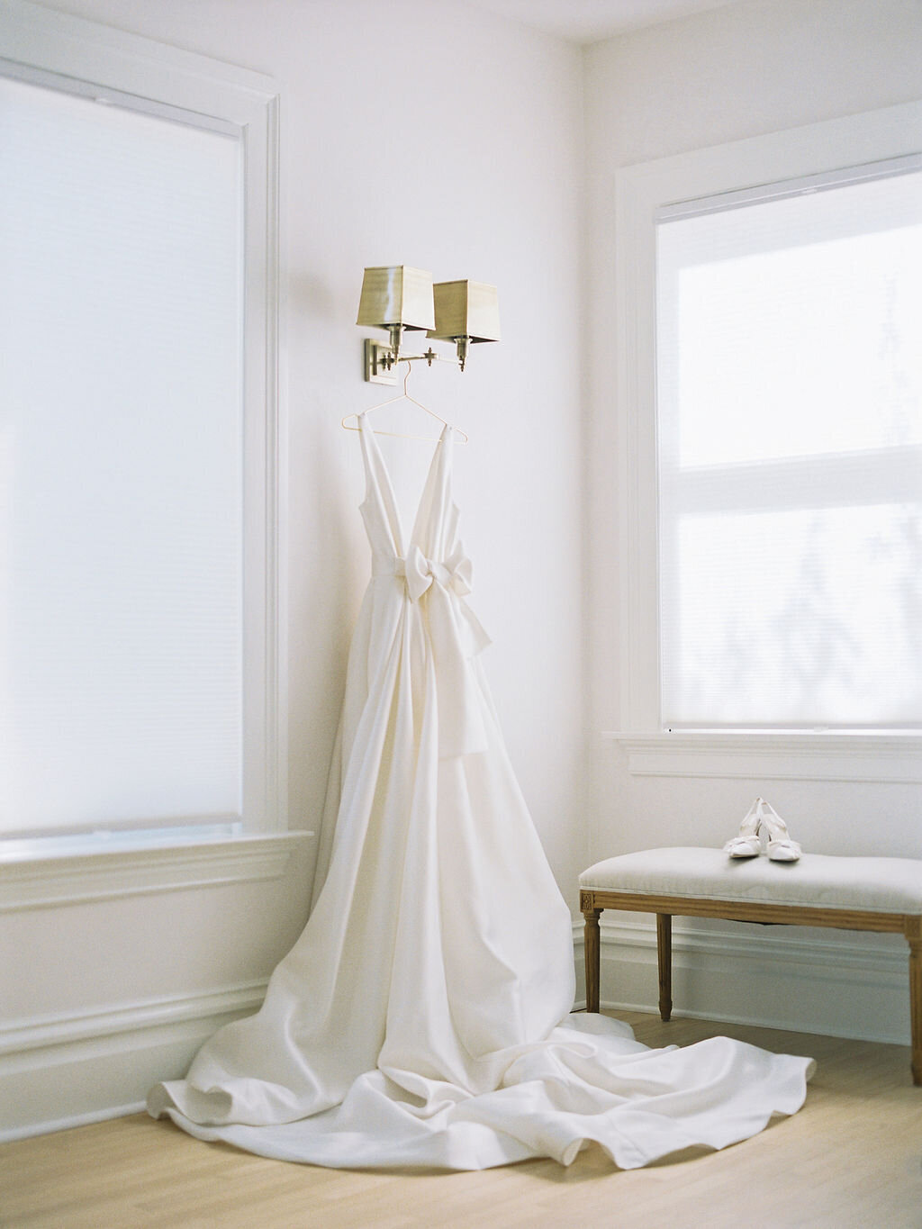 bridal gown hanging in room