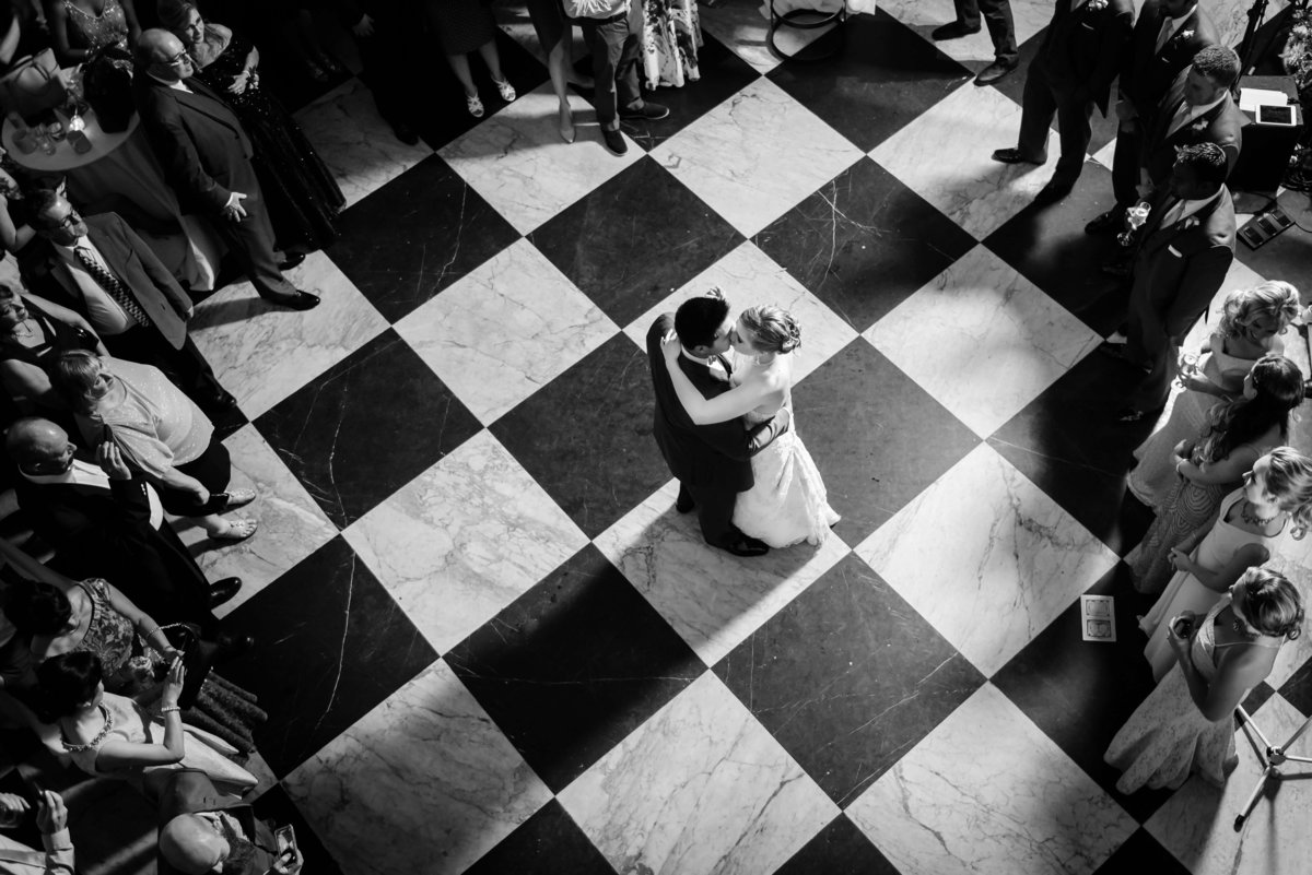 Birds eye view of a Bride and Groom during their first dance on the checkerboard tile floor of The Oxford Exchange